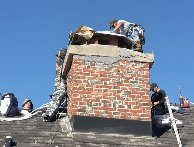 Deerfield Beach Chimney Sweep installing a custom chimney crown in Deerfield Beach, FL