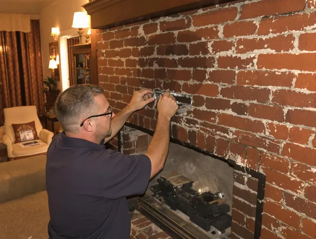 Deerfield Beach Chimney Sweep expert fixing a fireplace in Deerfield Beach, FL